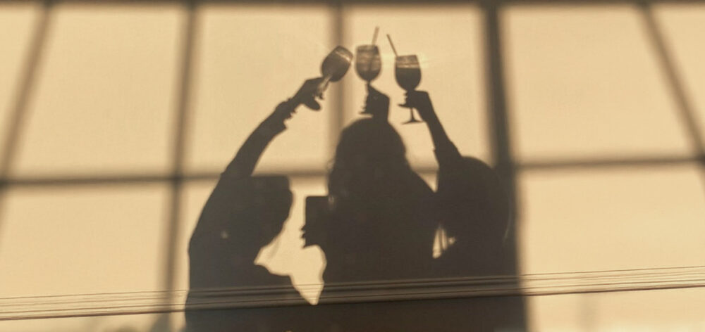 Midlife woman considering the impact of social drinks on menopause and hormones.