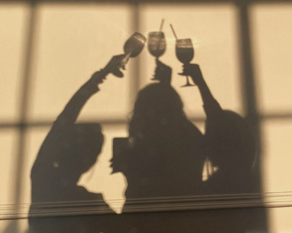 Midlife woman considering the impact of social drinks on menopause and hormones.