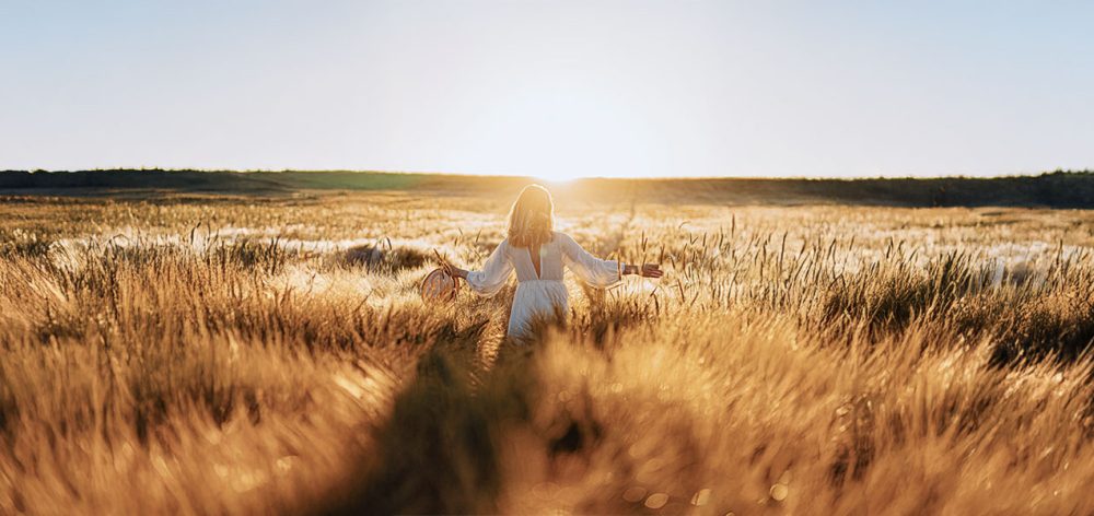 An active woman in her 50s jogging or hiking, symbolising heart and bone health through estrogen replacement.