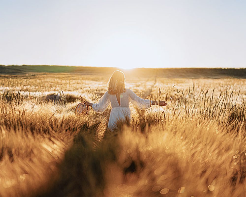 An active woman in her 50s jogging or hiking, symbolising heart and bone health through estrogen replacement.